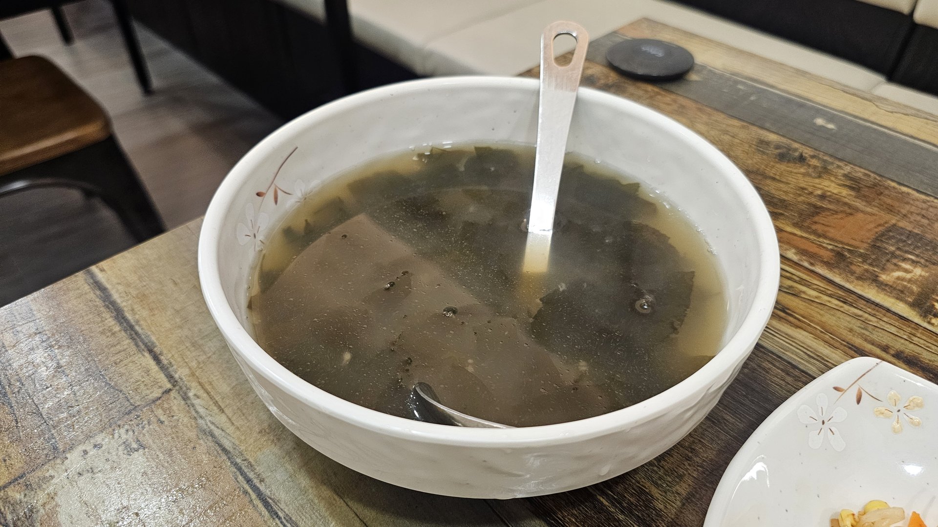 Seaweed soup in white bowl served as part of the kkokak bibimbap lunch set