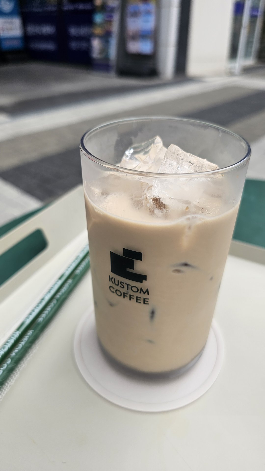 Close-up of iced milk tea with large ice cubes and clean milk base at Kustom Coffee Yeouido