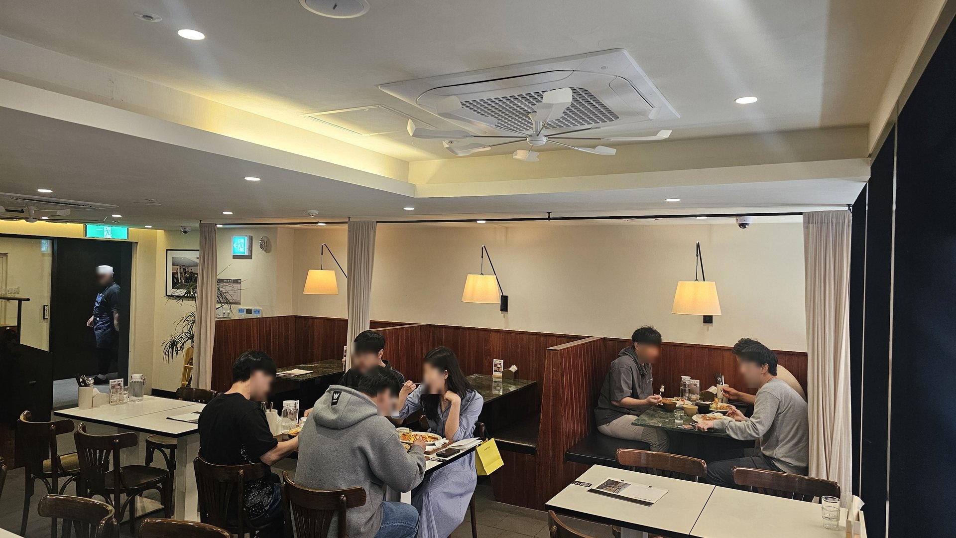 Dining room at Keebo Rock and Roll Yeouido with dark wood booths and lunch crowd