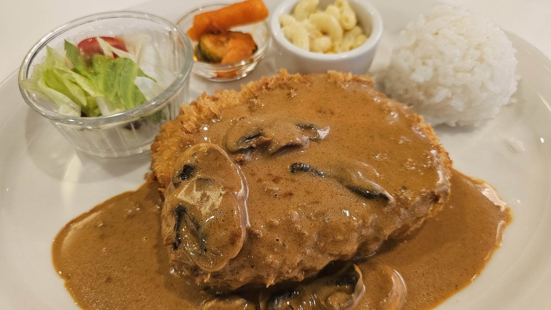 Close-up of pork donkatsu with rich mushroom demi-glace sauce at Keebo Rock and Roll Yeouido
