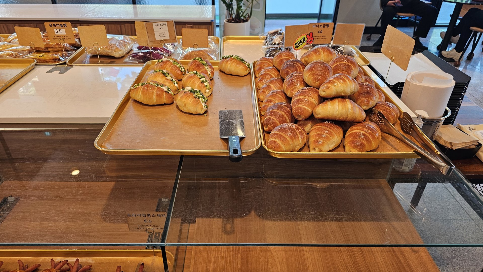 Close-up of salt bread butter rolls and sandwich trays at Mochang-po Bakery Cafe Boryeong