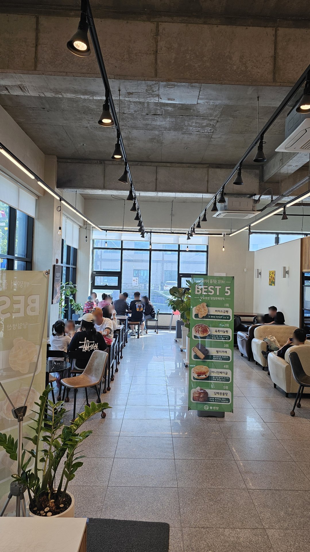 Wide interior view of Mochang-po Bread Cafe with high ceilings, customers, and BEST 5 banner