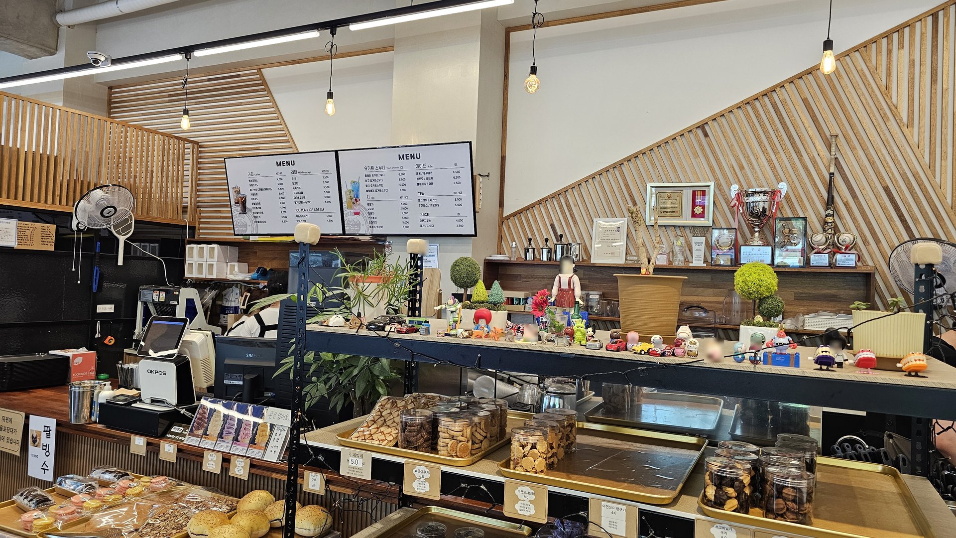Counter area with drink menu board, coffee machine, and bakery decor at Mochang-po Bread Cafe