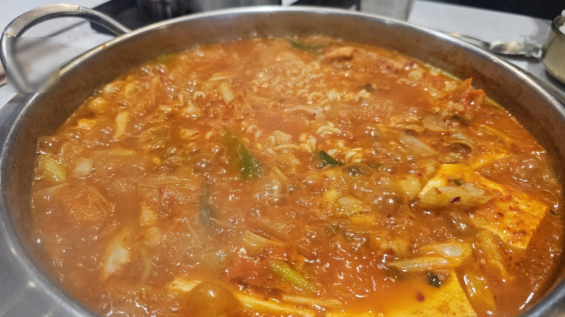 Fully boiling kimchi jjigae with ramen noodles at Shindosegi Yeouido