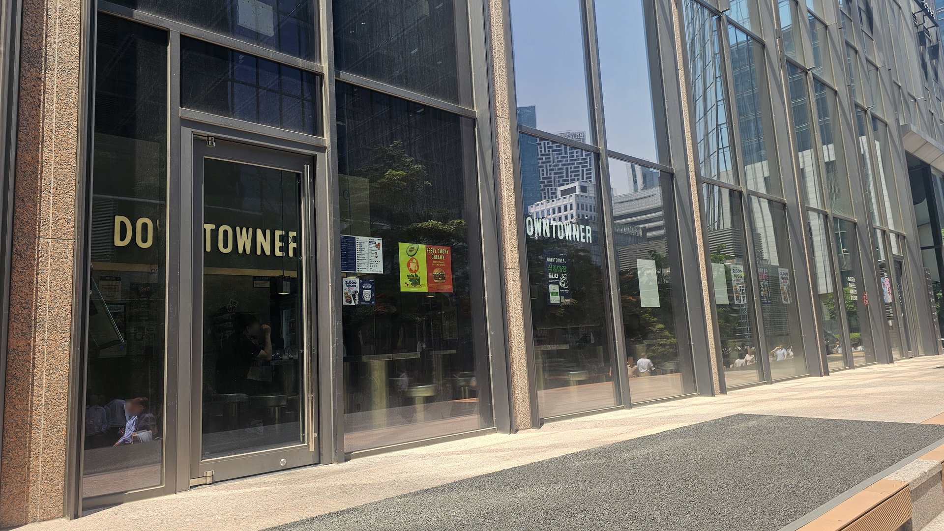 Downtowner Yeouido branch exterior with glass facade and DOWNTOWNER logo sign