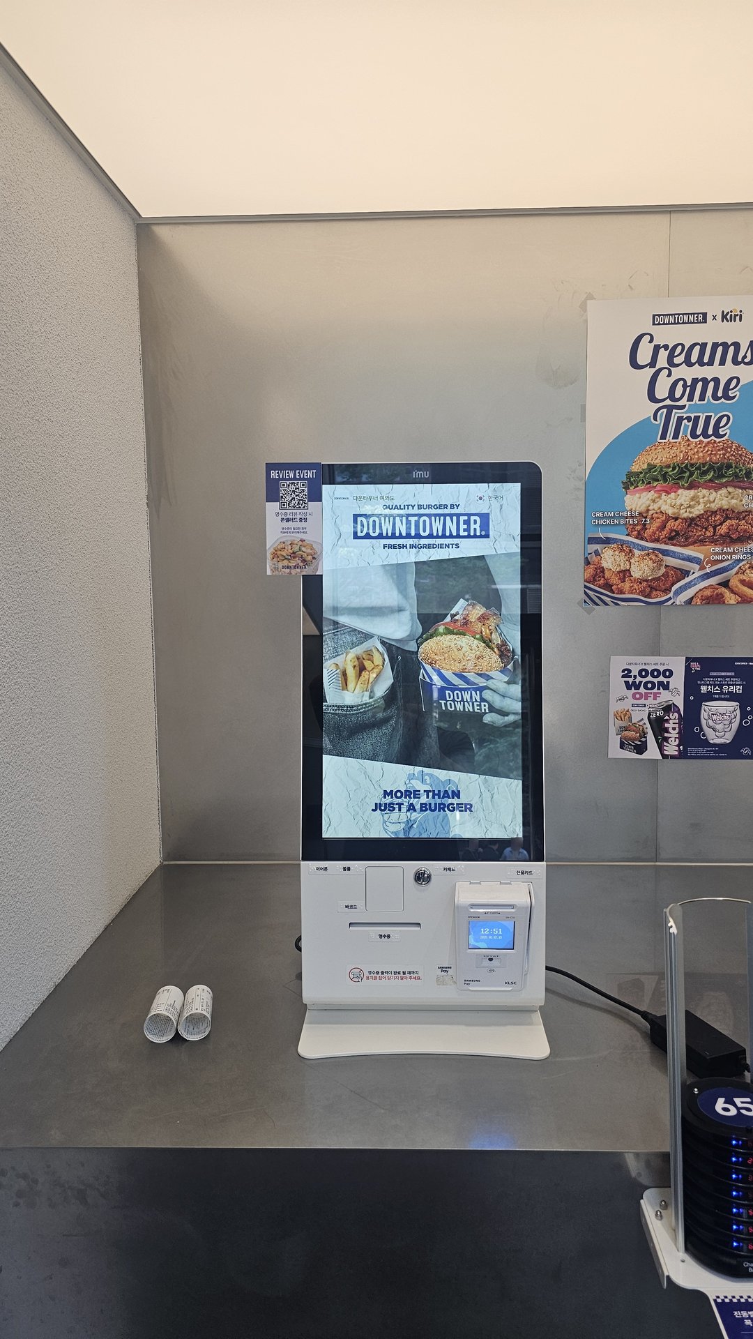 Downtowner kiosk screen showing DOWNTOWNER x Kiri cream collab promotion and order waiting screen
