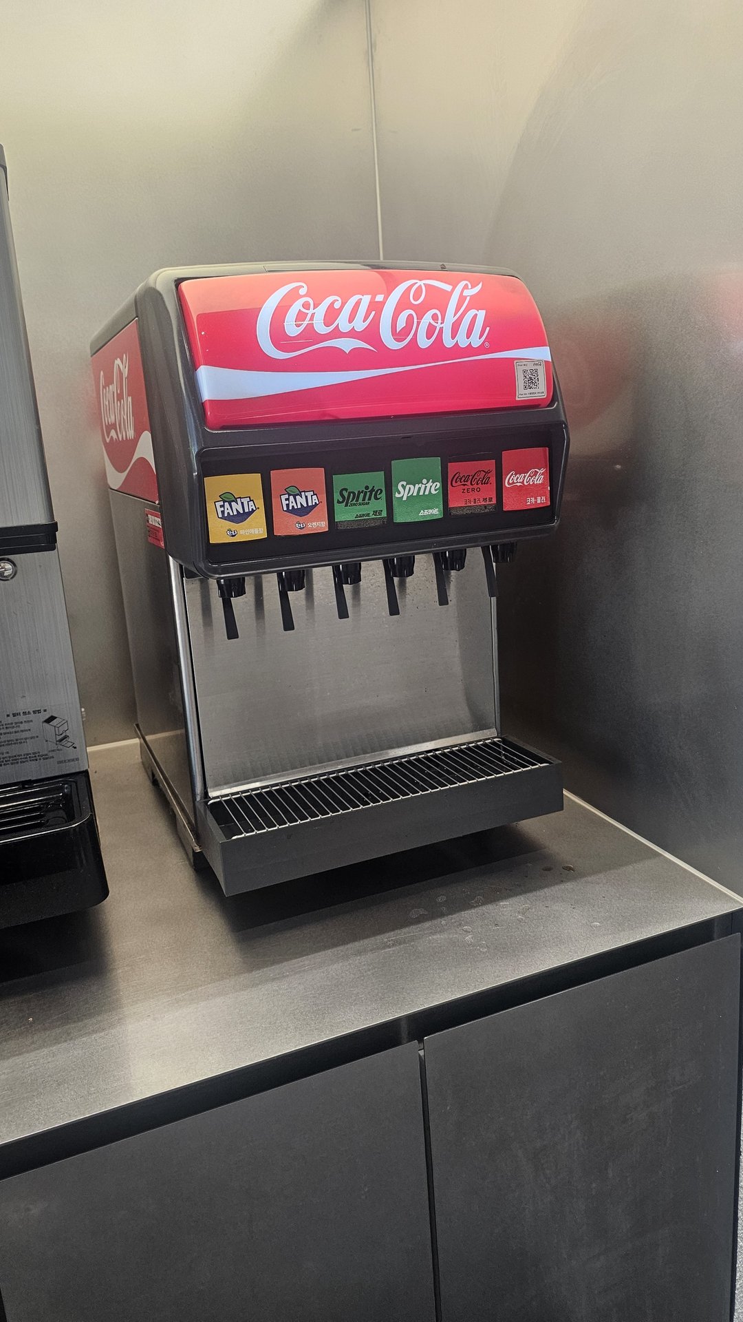 Self-serve Coca-Cola fountain dispenser at Downtowner Yeouido with Coke, Coke Zero, Sprite, and Fanta options