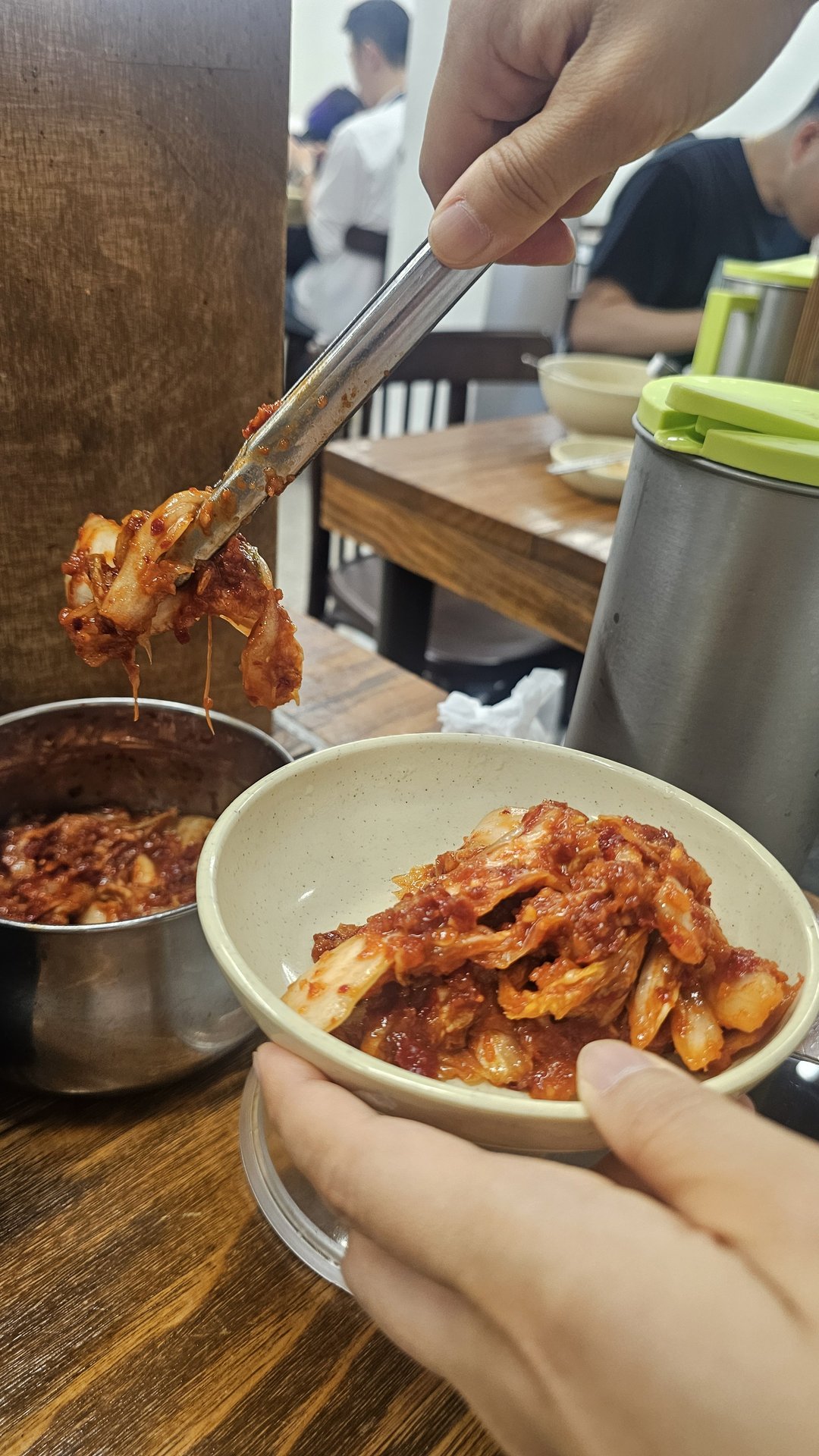 Self-service kimchi station with tongs at Myeongdong Gyoja