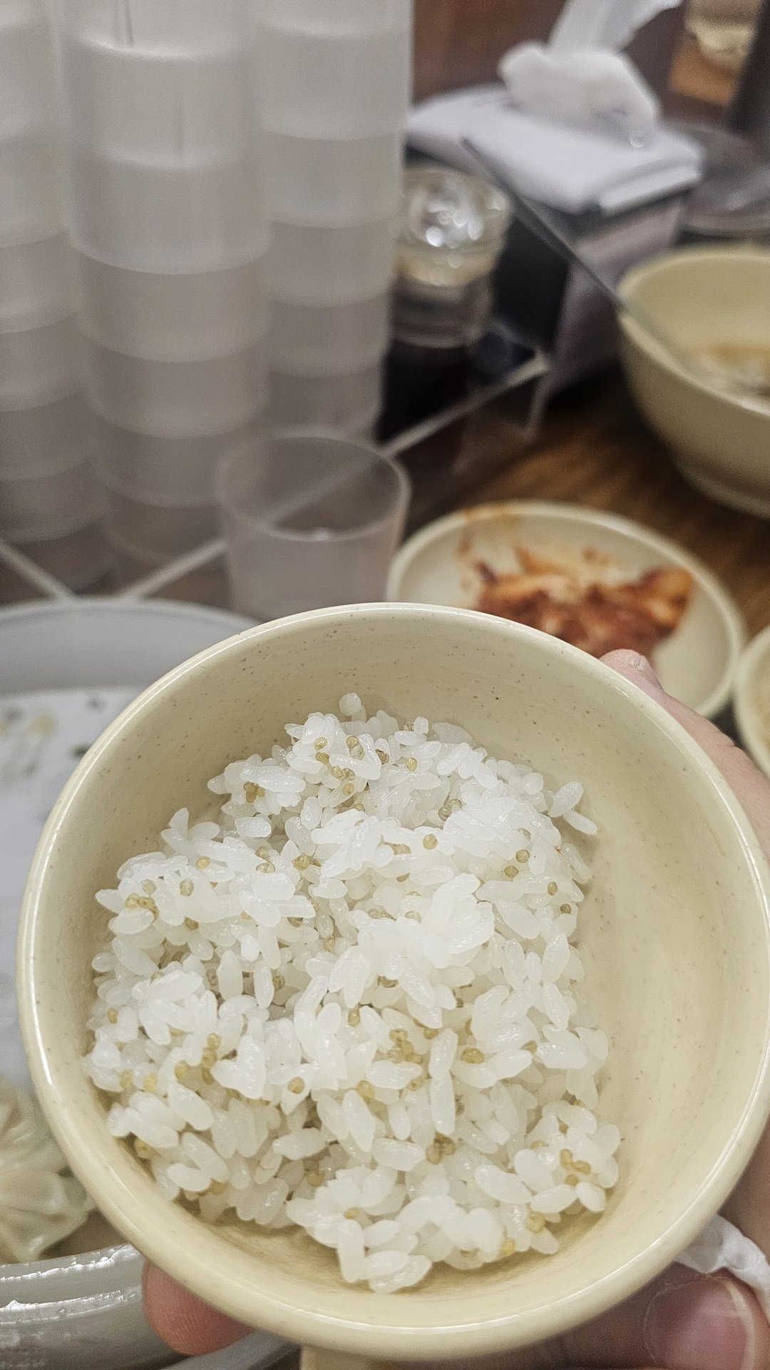 Small white rice bowl held in hand at Myeongdong Gyoja