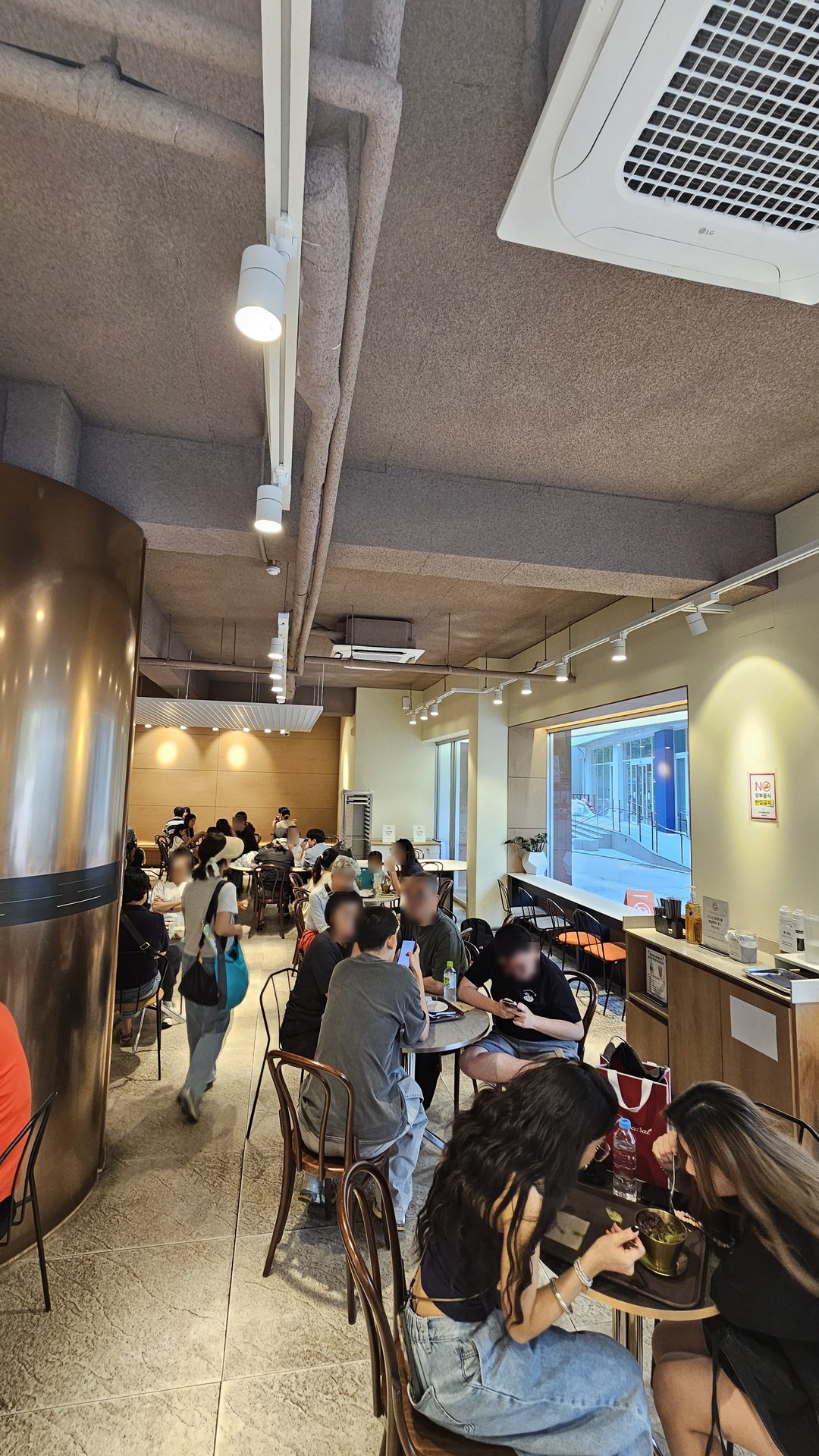 Crowded interior of Patgodang Myeongdong with seated customers and a waiting line near the entrance