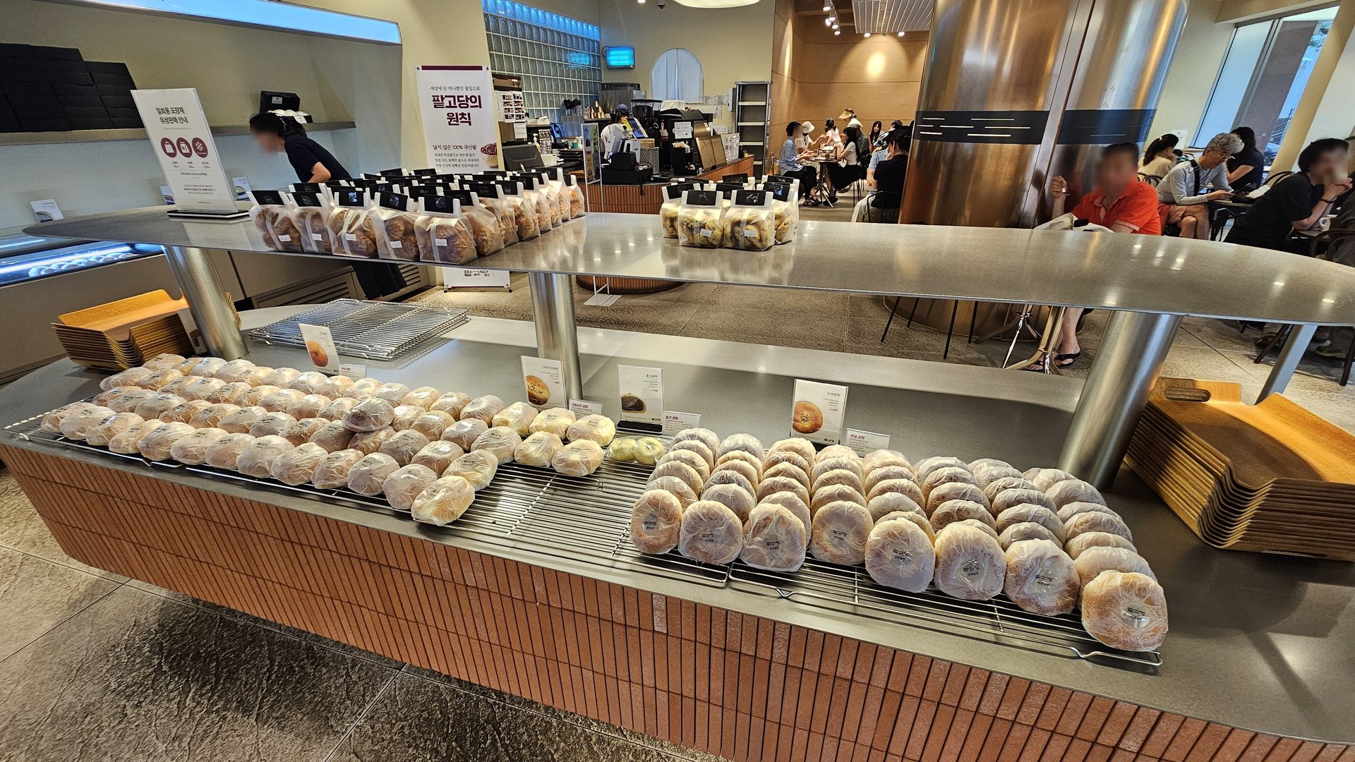 Counter display at Patgodang Myeongdong showing assorted red bean breads with beverage shelves behind