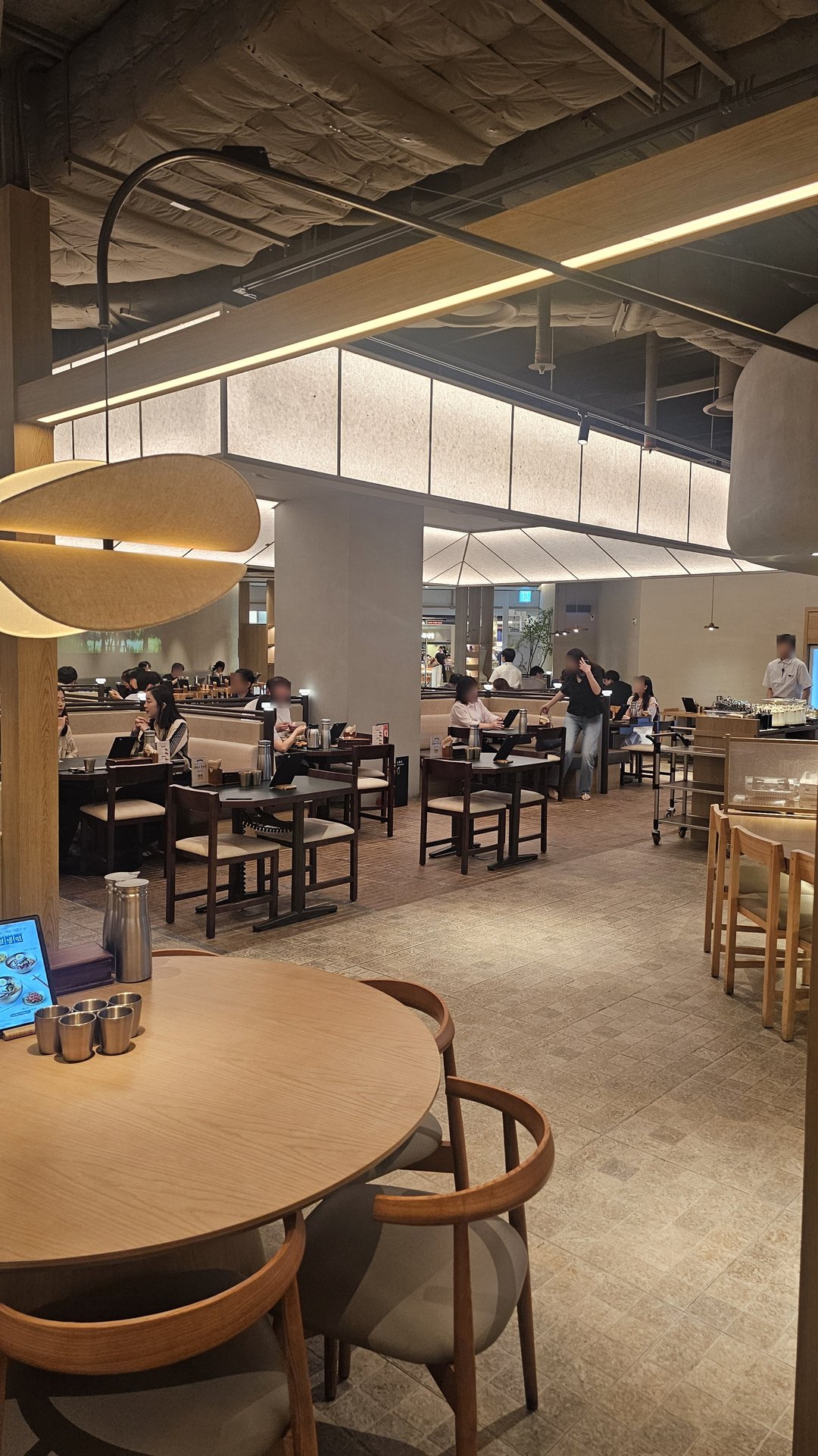 Busy weekday lunch service at Jeil Myeonso Yeouido with customers seated and staff in motion
