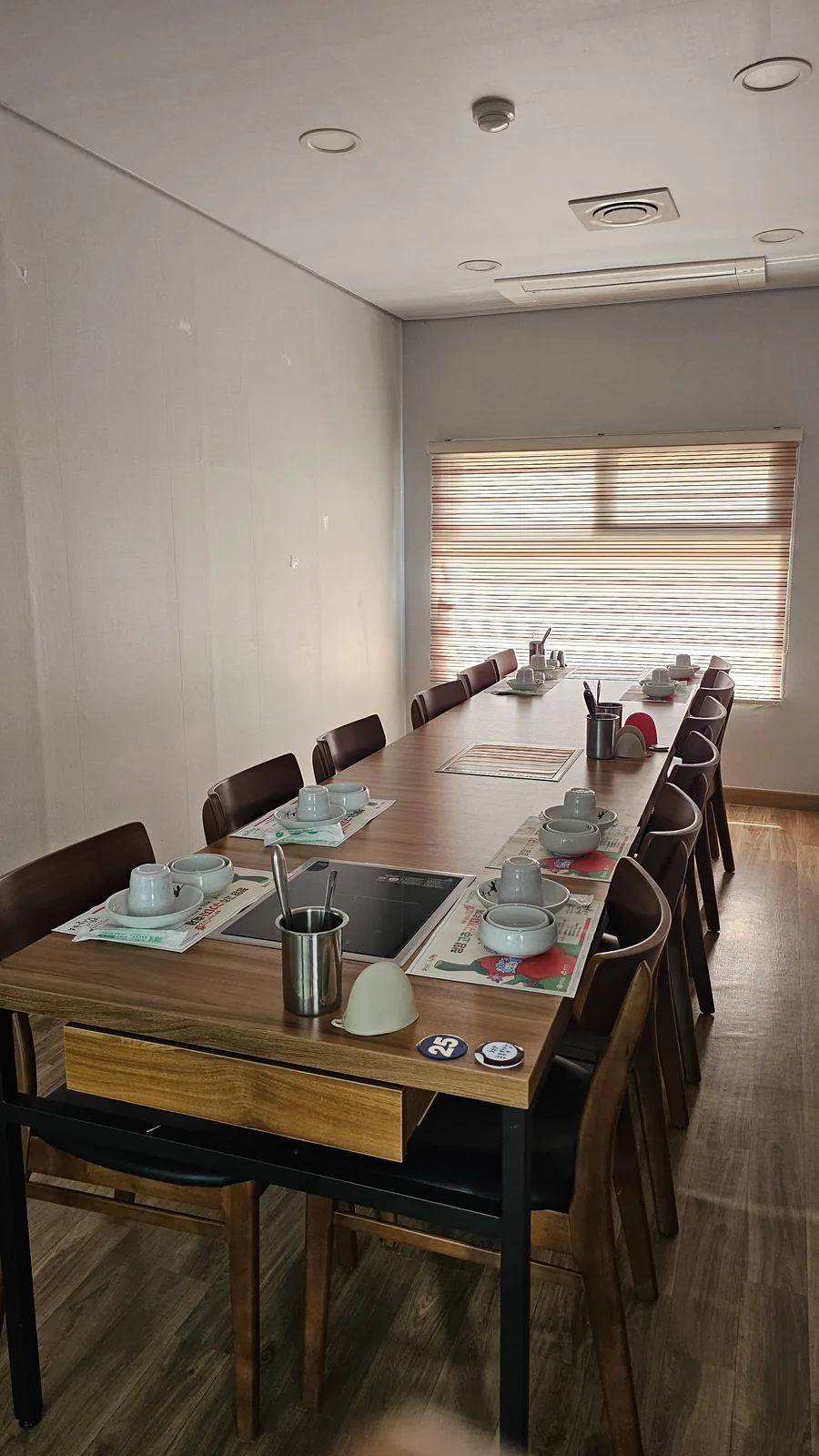 Private group dining room at Nongbu Bapsang with long table set for 12 and induction cooktop built into table