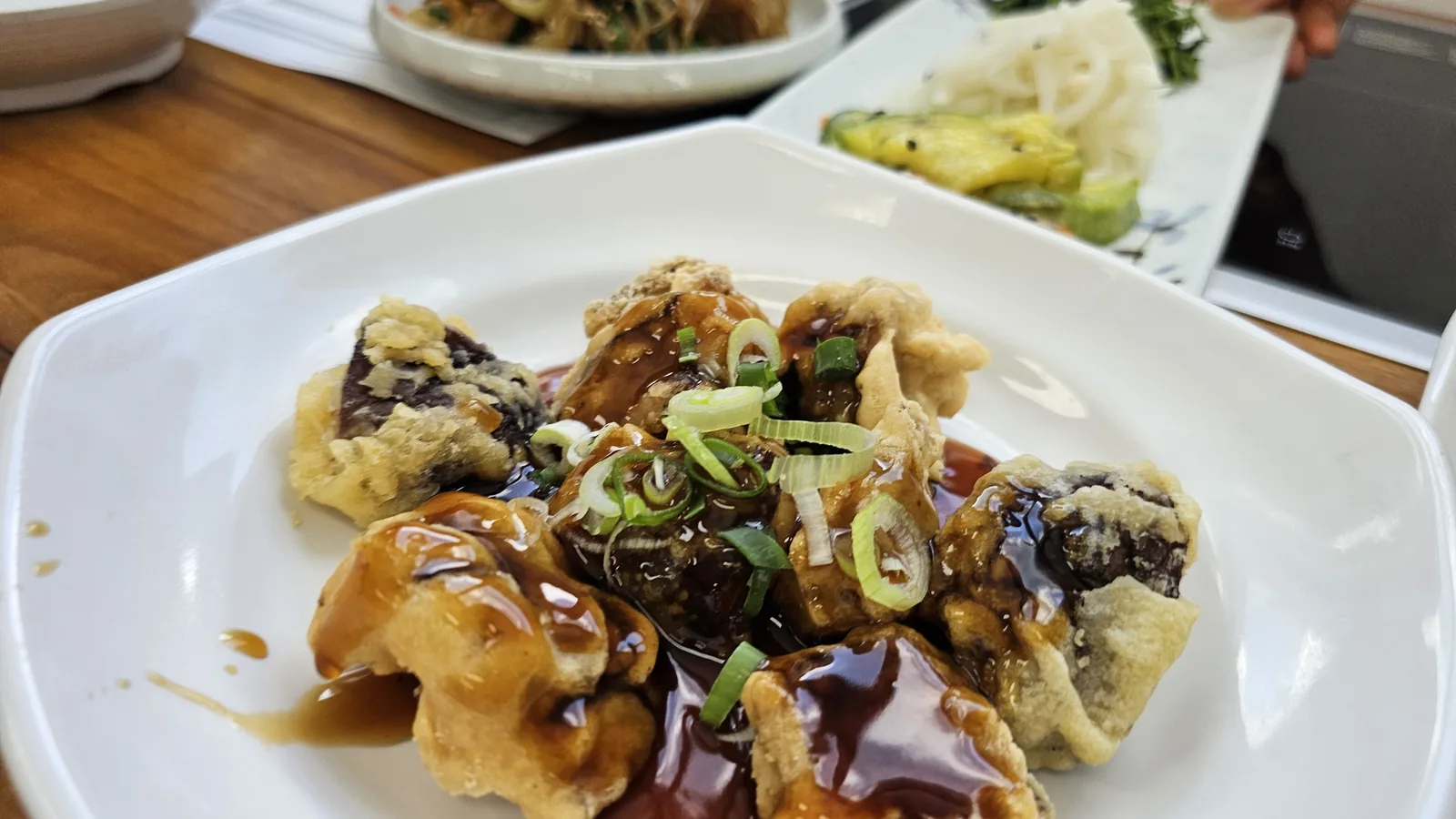 Shiitake tangsu at Nongbu Bapsang — battered and fried shiitake mushrooms in sweet glaze with green onion garnish